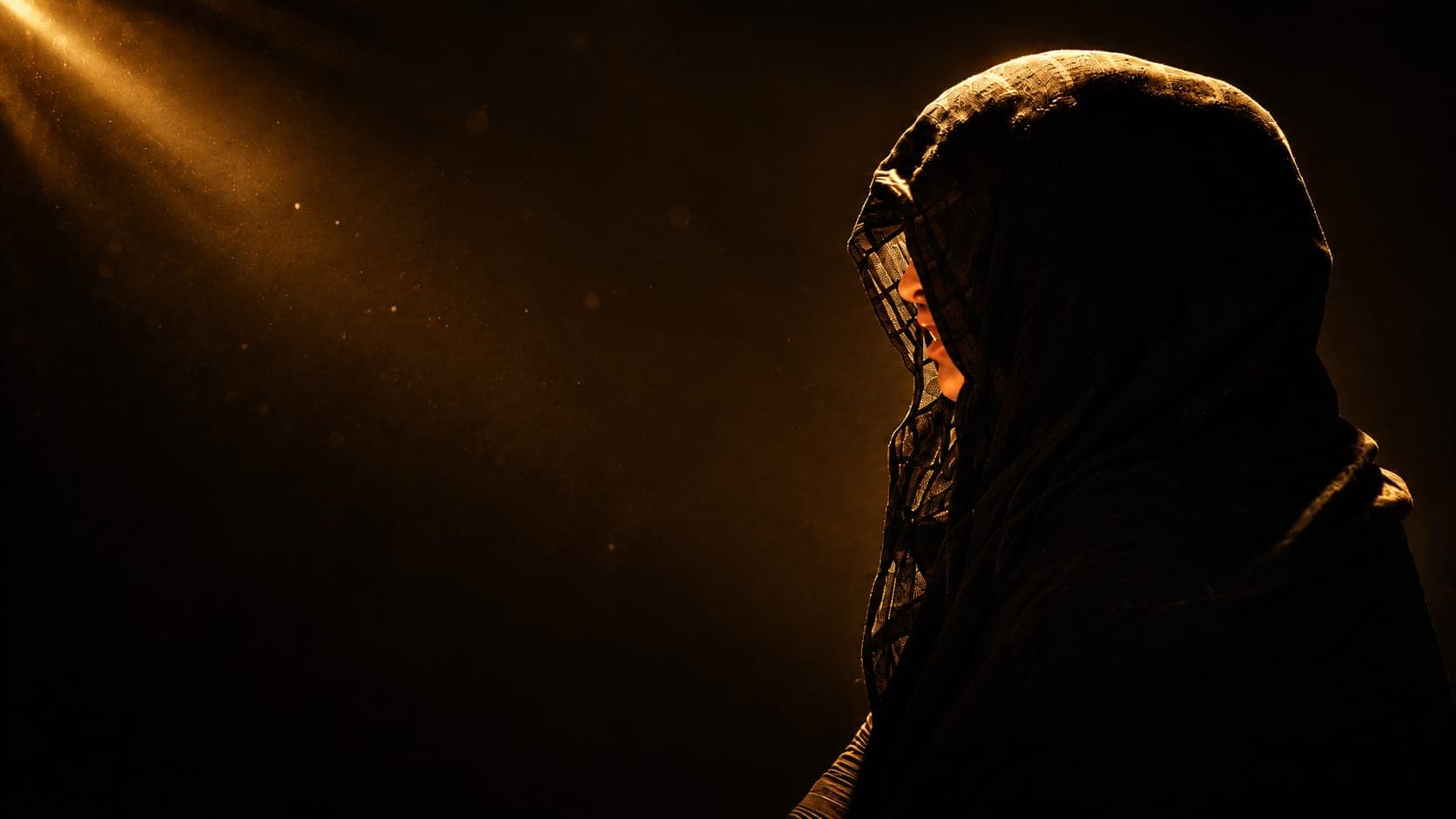 An anonymised silhouette of a young woman in a headscarf, turned away from the camera, lit by a single shaft of warm light.